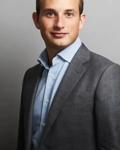 Alex Witkoff in a gray suit and light-blue shirt against a gray studio background.