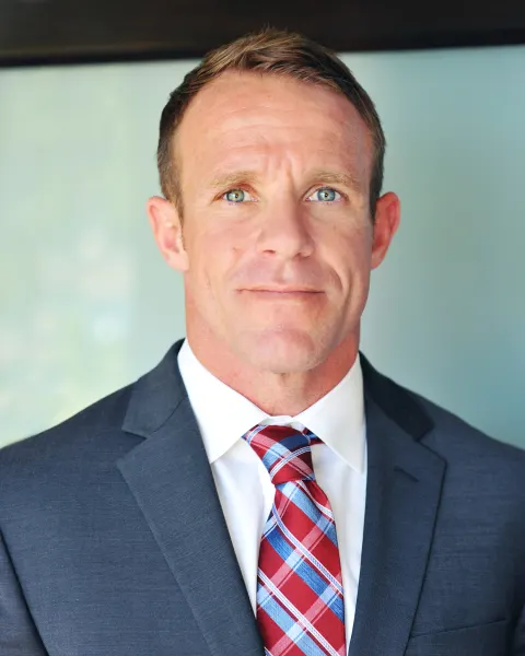 Retired Navy SEAL Edward Gallagher in a suit and tie.