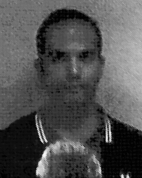 Black-and-white Department of Justice booking photograph of George Papadopoulos.