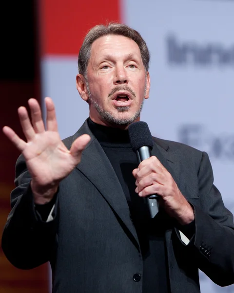 Larry Ellison speaking into a handheld microphone.